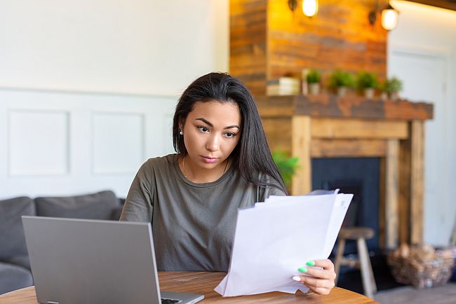 A woman working on her university degree evaluation documents