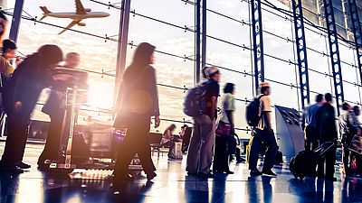 A group of people waiting at the airport to enter Germany